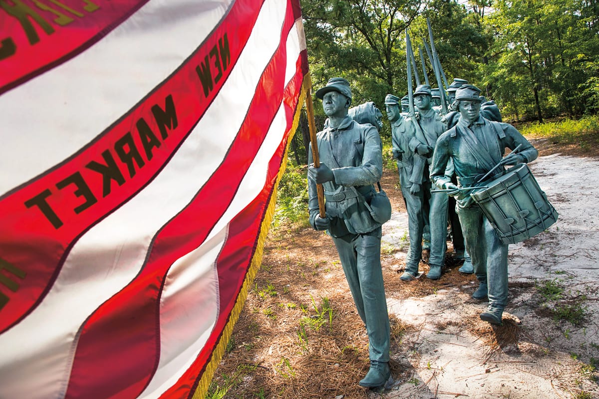 Statues of soldiers holding an American flag