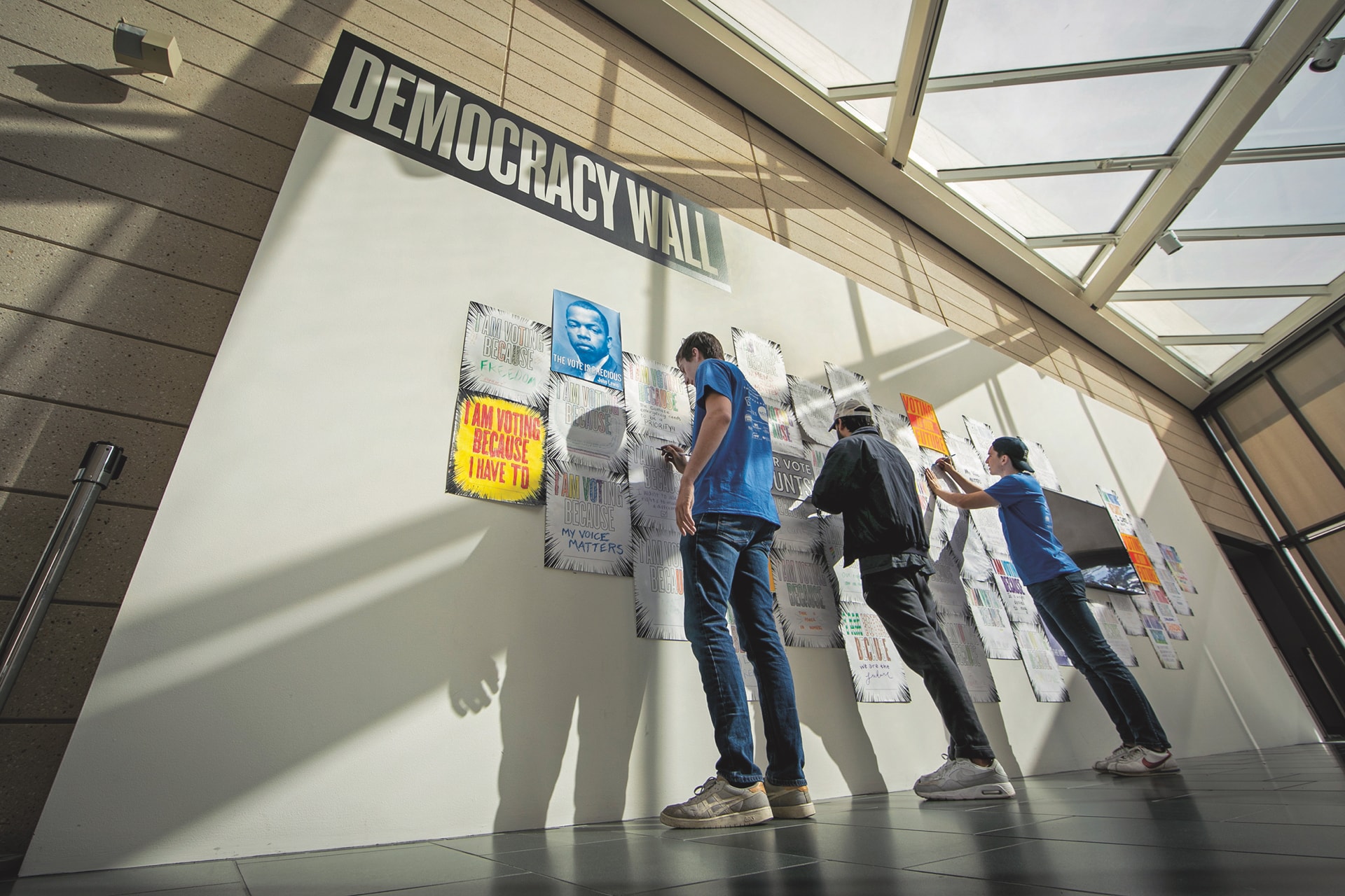 Students add their posters to the Democracy Wall at the Nasher Museum. Photo by Chris Hildreth