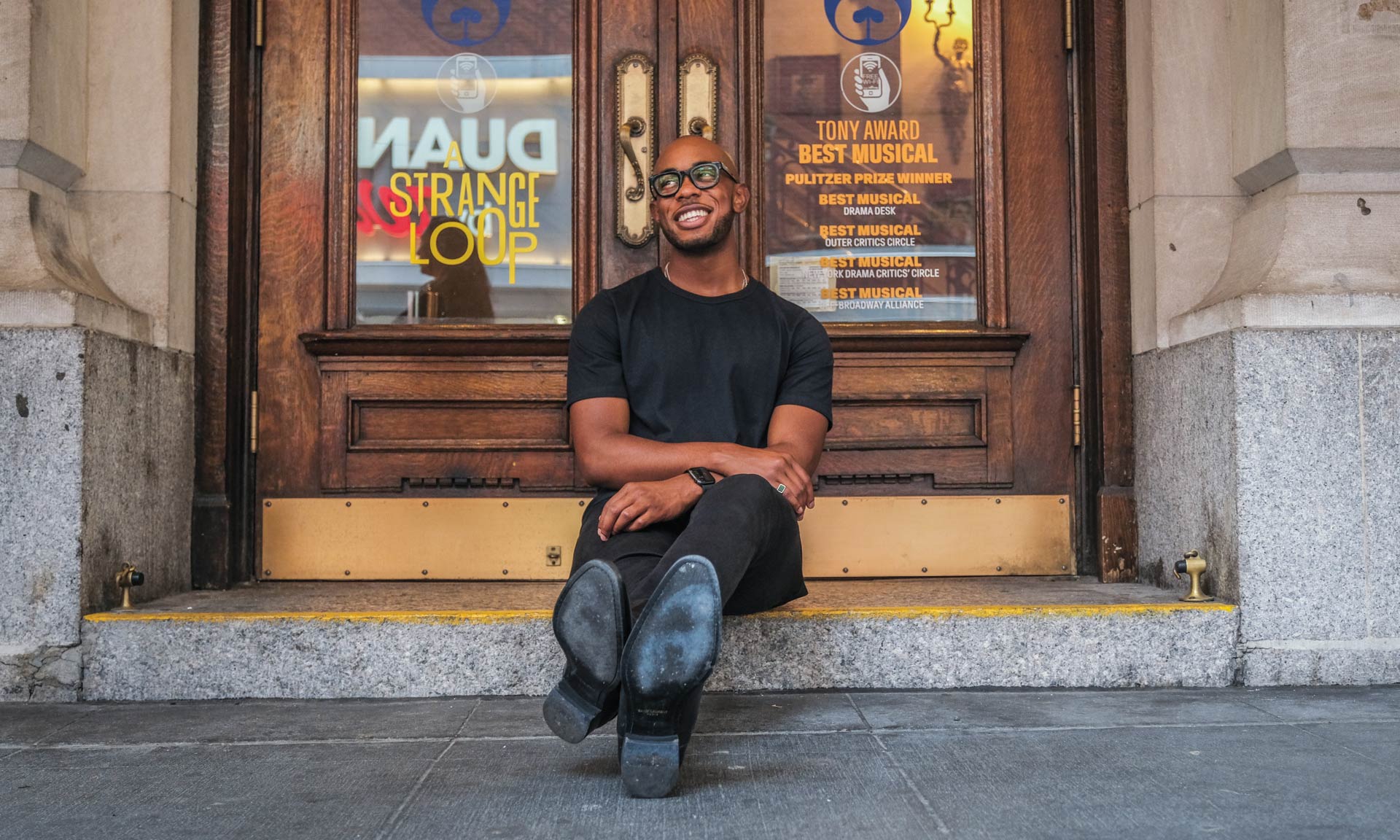 Scott enjoys a moment of calm on the steps of New York City’s Lyceum Theatre.