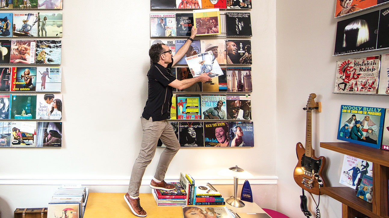 Wayne Norman adjusts and album in his office