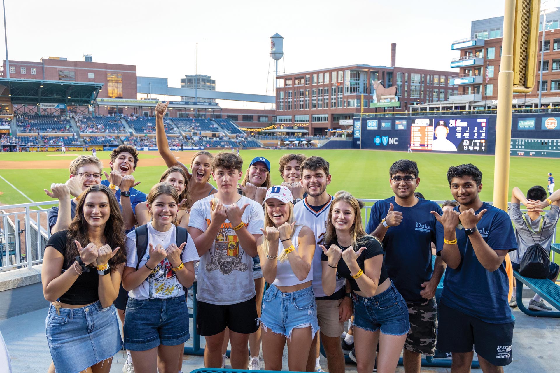 Students showing the Durham Bull City sign