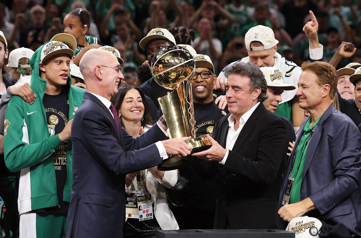 Adam Silver presents NBA championship trophy to the owners of the team.