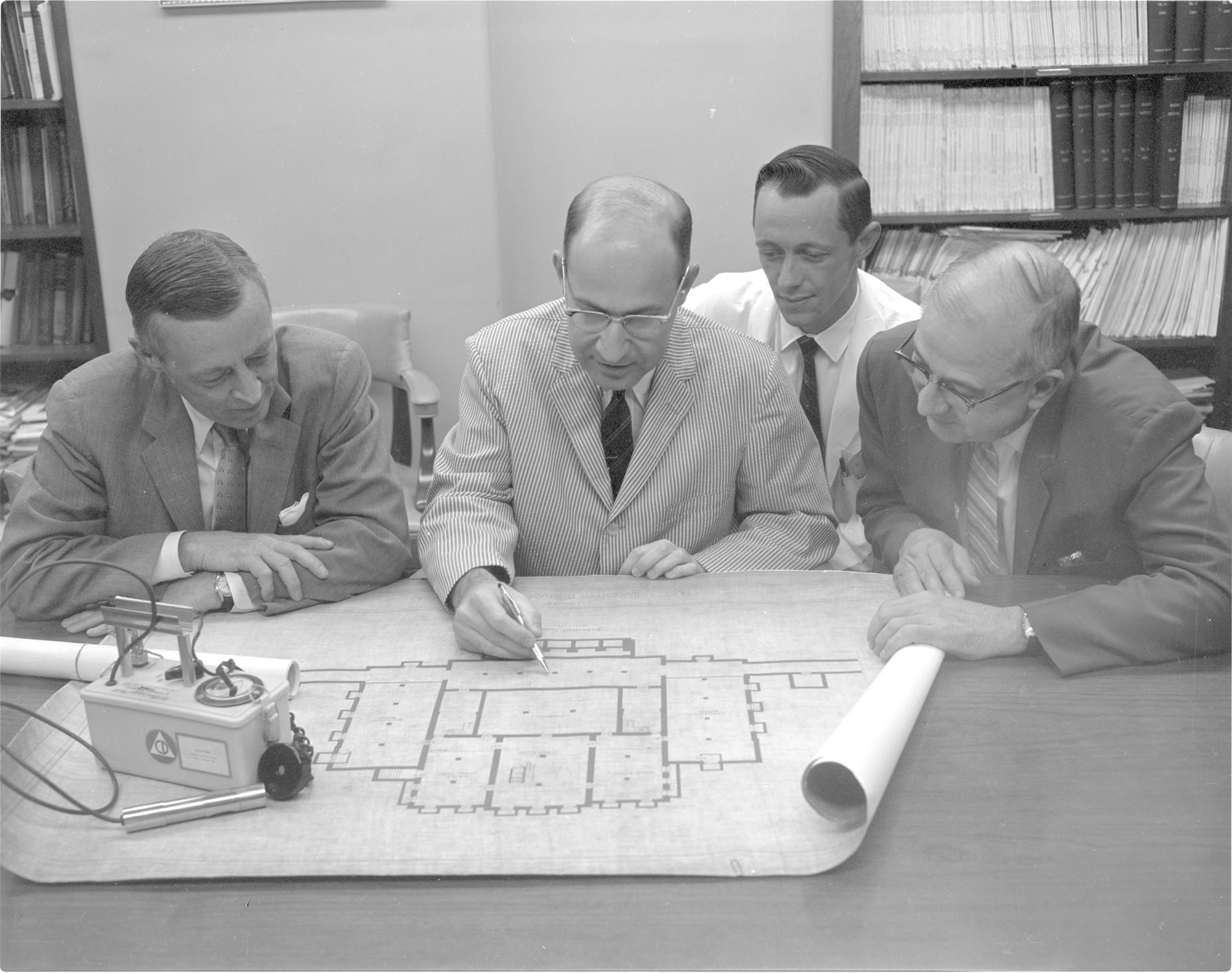 Men looking at a building layout