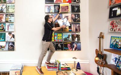 Wayne Norman adjusts and album in his office