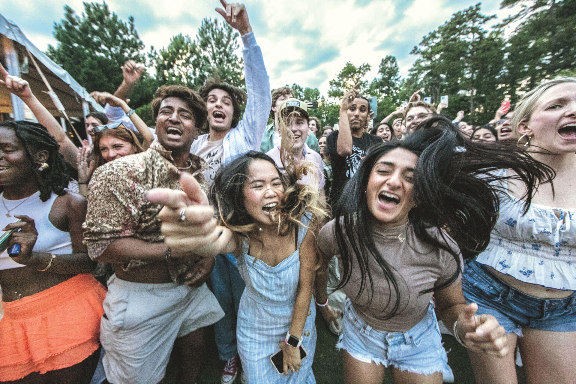 THUMBNAIL: Students vibe to a "Music in the Gardens" performance during orientation.