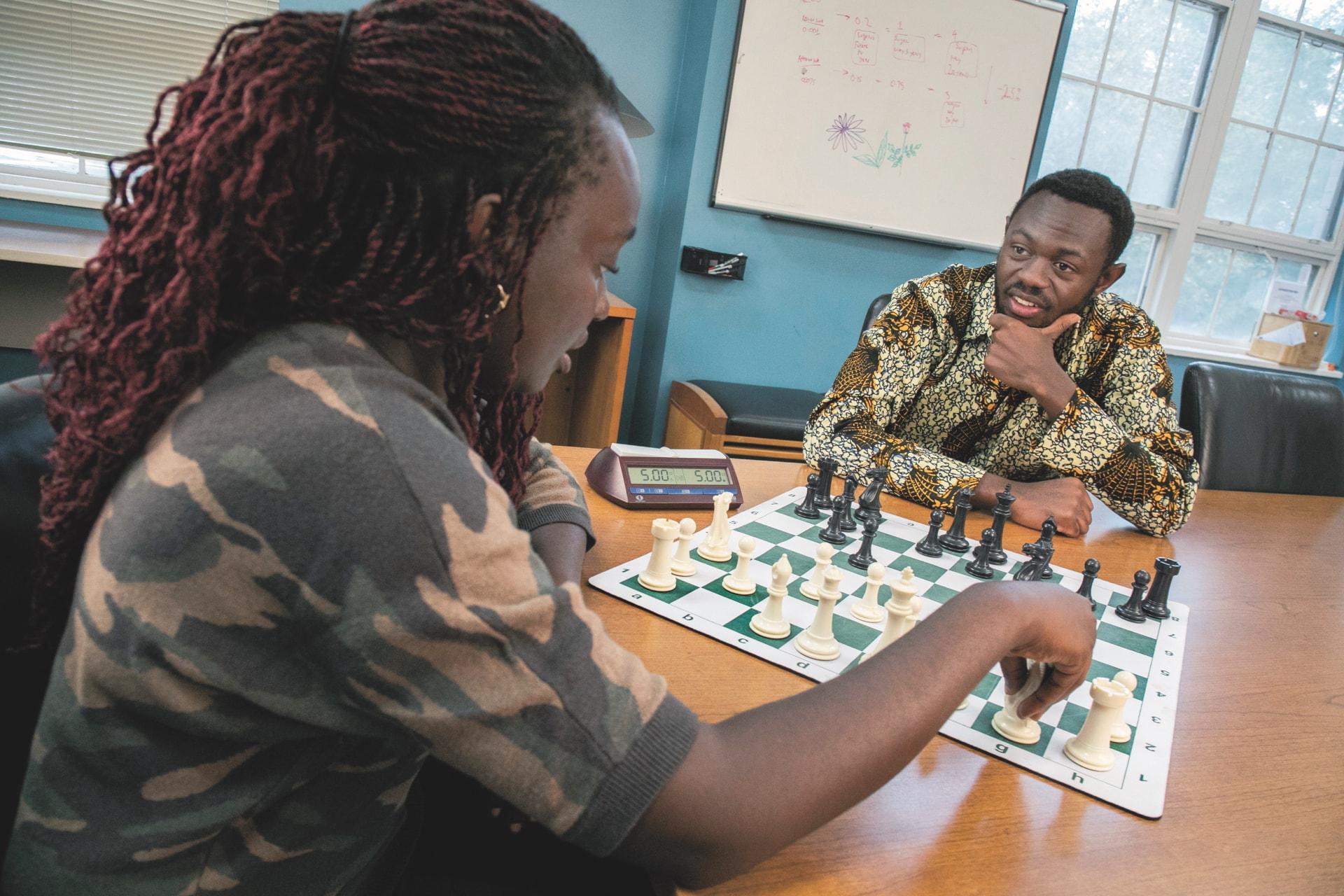 THUMBNAIL: Global health master's student Ben Mukumbya teaching chess.