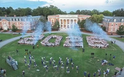 Class of 2026 gathered together on the lawn of the campus in an aerial photograph. 